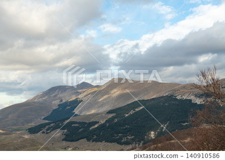 Scenic panoramic view of Cinquemiglia highland plain in Apennines mountains Scenic panoramic view of Cinquemiglia highland plain in Apennines mountains 140910586