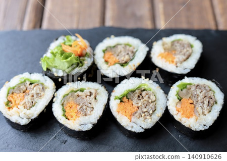 Korean seaweed rolls arranged on a slate plate: bulgogi kimbap Korean seaweed rolls arranged on a slate plate: bulgogi kimbap 140910626