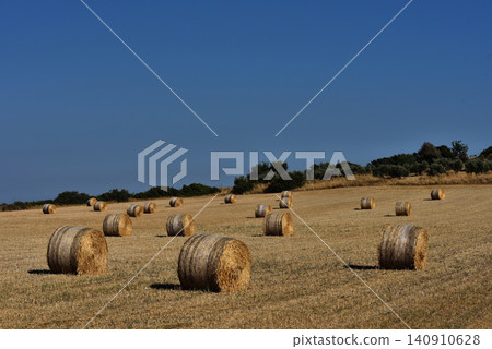 Straw bales on farmland with blue sky Straw bales on farmland with blue sky 140910628
