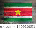 Suriname flag on rustic old wood surface background 140910851