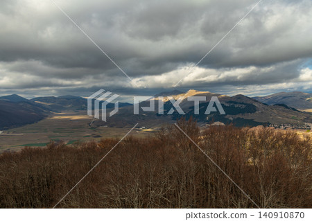 High angle view of a wide mountain valley under cloudy sky in Abruzzo region High angle view of a wide mountain valley under cloudy sky in Abruzzo region 140910870