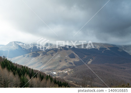 High angle view of a wide mountain valley under cloudy sky in Abruzzo region High angle view of a wide mountain valley under cloudy sky in Abruzzo region 140910885