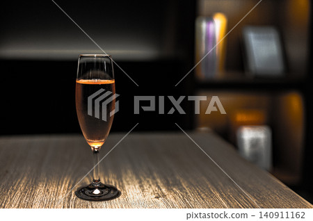 Rosé wine placed on a table in a dimly lit room Rosé wine placed on a table in a dimly lit room 140911162