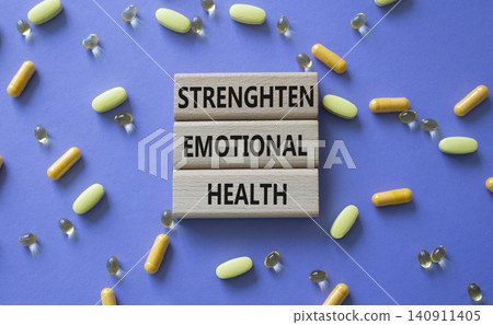 Strengthen emotional health symbol. Concept words Strengthen emotional health on wooden blocks. Beautiful purple background with pills. Healthcare and Strengthen emotional health concept. Copy space. Strengthen emotional health symbol. Concept words Strengthen emotional health on wooden blocks. Beautiful purple background with pills. Healthcare and Strengthen emotional health concept. Copy space. 140911405
