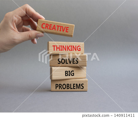 Creative Thinking symbol. Wooden blocks with words Creative Thinking Solves Big Problems. Businessman hand. Beautiful grey background. Businessman hand. Business and Creative Thinking concept. Copy Creative Thinking symbol. Wooden blocks with words Creative Thinking Solves Big Problems. Businessman hand. Beautiful grey background. Businessman hand. Business and Creative Thinking concept. Copy 140911411