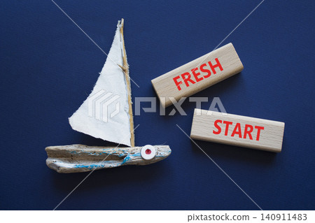 FRESH START symbol. Concept word FRESH START on wooden blocks. Beautiful deep blue background with boat. Business and FRESH START concept. Copy space 140911483