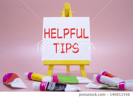 Helpful tips symbol. Wooden blocks with words Helpful tips. Beautiful pink background with paints and easel. Business and Helpful tips concept. Copy space. Helpful tips symbol. Wooden blocks with words Helpful tips. Beautiful pink background with paints and easel. Business and Helpful tips concept. Copy space. 140911548