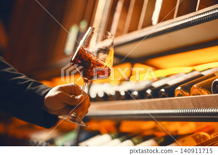 Swirling Red Wine in Elegant Cellar Swirling Red Wine in Elegant Cellar 140911715