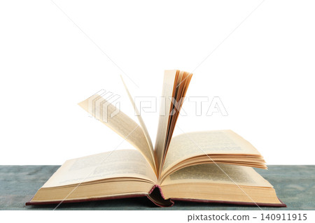 Open old hardcover book on wooden table 140911915