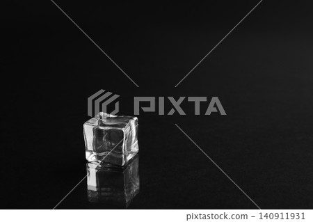 Crystal clear ice cube on black background. Space for text Crystal clear ice cube on black background. Space for text 140911931