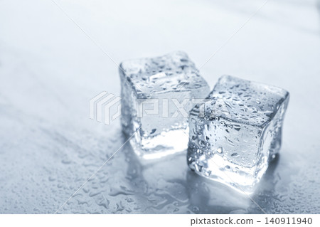 Crystal clear ice cubes with water drops on light table, closeup Crystal clear ice cubes with water drops on light table, closeup 140911940