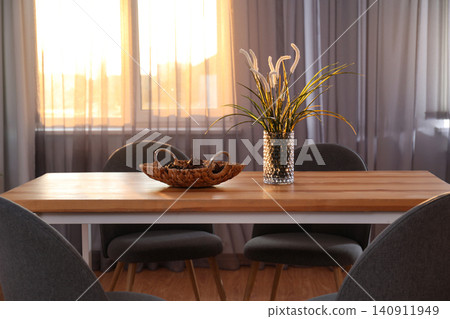 Vase on wooden table near window with curtains in room Vase on wooden table near window with curtains in room 140911949