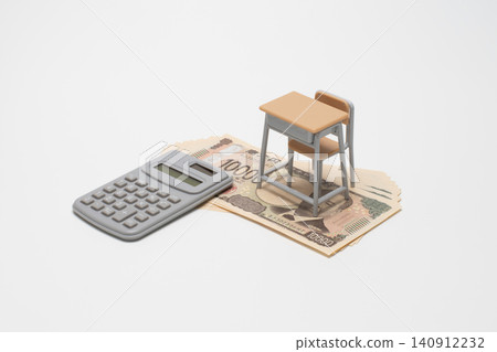 A school desk, calculator, and 10,000 yen bill are depicted to represent the burden of education expenses, school fees, or tuition fees on household finances. A school desk, calculator, and 10,000 yen bill are depicted to represent the burden of education expenses, school fees, or tuition fees on household finances. 140912232