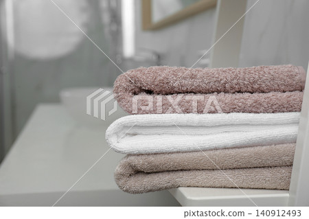 Fresh laundry on table in bathroom, closeup Fresh laundry on table in bathroom, closeup 140912493