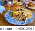 A hearty cheeseburger and French fries set from a cafe. 140912591