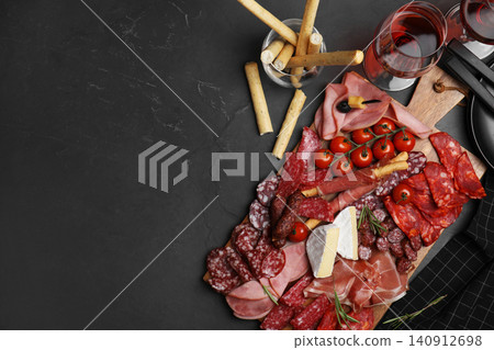 Tasty ham with other delicacies served on black table, flat lay. Space for text Tasty ham with other delicacies served on black table, flat lay. Space for text 140912698