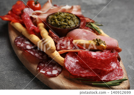 Tasty ham and other delicacies served on grey table, closeup Tasty ham and other delicacies served on grey table, closeup 140912699
