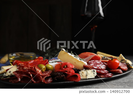 Tasty ham with other delicacies served on grey table Tasty ham with other delicacies served on grey table 140912700