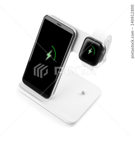Mobile phone and smartwatch charging with wireless pad isolated on white Mobile phone and smartwatch charging with wireless pad isolated on white 140912800