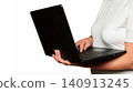 person types on a black laptop while holding it in the air with hands 140913245