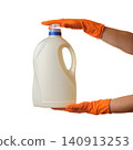 white canister with a blue cap under an orange glove on a white background 140913253