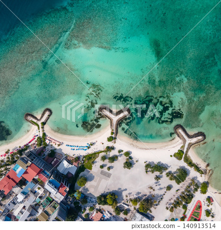 Aerial view of beachfront hotels and private beach at Maafushi island, Maldives Aerial view of beachfront hotels and private beach at Maafushi island, Maldives 140913514
