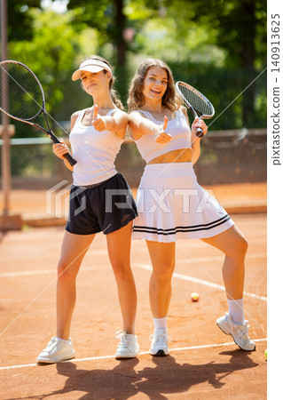 Tennis players show confidence before their match on a sunny day at a local court Tennis players show confidence before their match on a sunny day at a local court 140913625