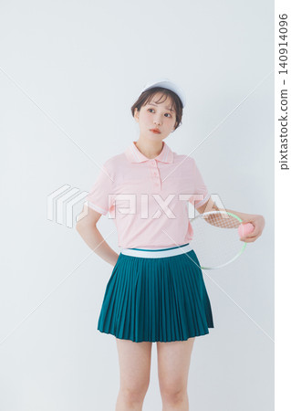 young woman in tennis attire 140914096