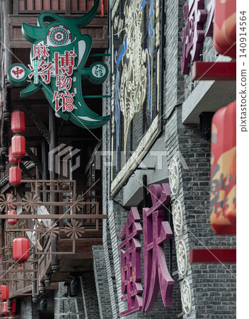 Traditional grey brick architecture and dark timber frames create a timeless backdrop for the vibrant, stylized signage of Ciqikou Ancient Town, where elegant purple Chinese characters and a striking Traditional grey brick architecture and dark timber frames create a timeless backdrop for the vibrant, stylized signage of Ciqikou Ancient Town, where elegant purple Chinese characters and a striking 140914564