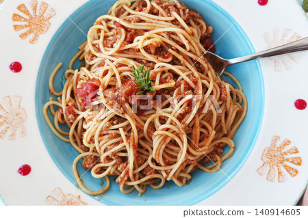 Traditional spaghetti Bolognese served with rich meat tomato sauce and rosemary garnish on a colorful plate. Ideal for restaurant menus, Italian cuisine, food blogs, and dining concepts Traditional spaghetti Bolognese served with rich meat tomato sauce and rosemary garnish on a colorful plate. Ideal for restaurant menus, Italian cuisine, food blogs, and dining concepts 140914605