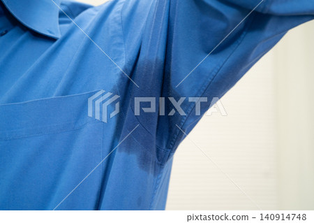 Man with sweaty arm pit on shirt when working in office, Hyperhidrosis sweating. Man with sweaty arm pit on shirt when working in office, Hyperhidrosis sweating. 140914748