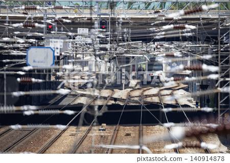 Train approaches the station as infrastructure and tracks are visible Train approaches the station as infrastructure and tracks are visible 140914878
