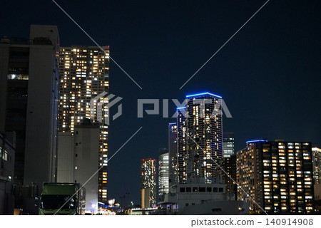 在東京豐洲上空，一群高聳的公寓大樓在夜空中熠熠生輝。 140914908