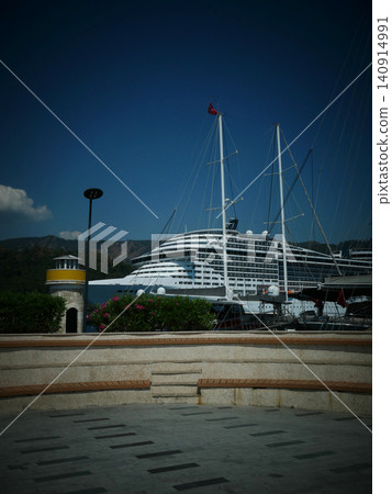 Large cruise ship docked at a harbor with small lighthouse Large cruise ship docked at a harbor with small lighthouse 140914991