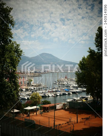 White sailboats and yachts moored at a coastal marina 140914996