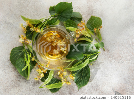 Linden tea with fresh tilia flowers and leaves Linden tea with fresh tilia flowers and leaves 140915116