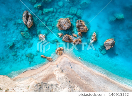 Aerial view of blue sea, rocks in clear water, white sandy beach Aerial view of blue sea, rocks in clear water, white sandy beach 140915332