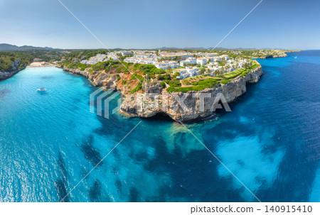 Aerial view of sea coast with white resort houses on rocky cliffs Aerial view of sea coast with white resort houses on rocky cliffs 140915410
