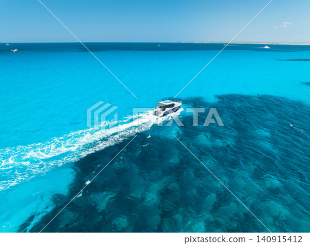 Aerial drone view of floating luxury yachts in blue sea. Boat Aerial drone view of floating luxury yachts in blue sea. Boat 140915412