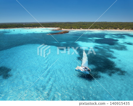 Aerial view of sailboat, turquoise sea near Mallorca sandy beach Aerial view of sailboat, turquoise sea near Mallorca sandy beach 140915435
