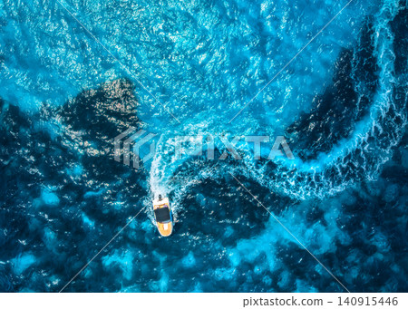Aerial drone view of motorboat with curved wake in turquoise sea 140915446