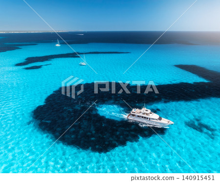 Aerial view of luxury yacht sailing in crystal clear blue sea Aerial view of luxury yacht sailing in crystal clear blue sea 140915451