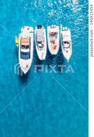 Aerial view of luxury yacht and boat in blue sea in summer Aerial view of luxury yacht and boat in blue sea in summer 140915454