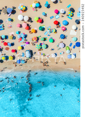 Aerial view of colorful umbrellas on sandy beach and blue sea Aerial view of colorful umbrellas on sandy beach and blue sea 140915492