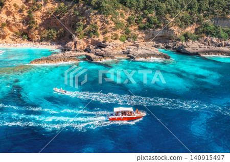 Aerial view of red speed boat, turquoise sea, sandy beach. Summer Aerial view of red speed boat, turquoise sea, sandy beach. Summer 140915497