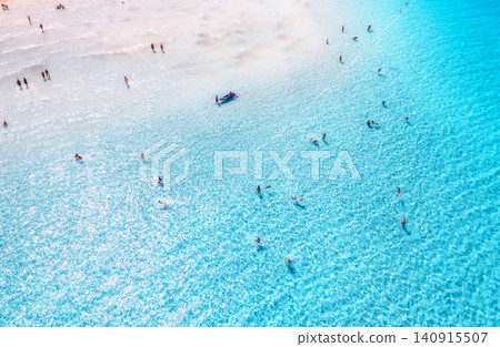 Aerial view of clear blue sea with swimming people. Top view Aerial view of clear blue sea with swimming people. Top view 140915507