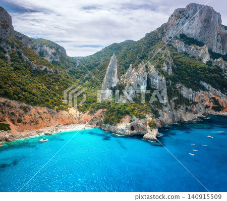Aerial view of rocks and mountains, blue bay, beach, boats Aerial view of rocks and mountains, blue bay, beach, boats 140915509