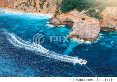 Aerial view of speed boats and sandy beach on sunny summer day Aerial view of speed boats and sandy beach on sunny summer day 140915512