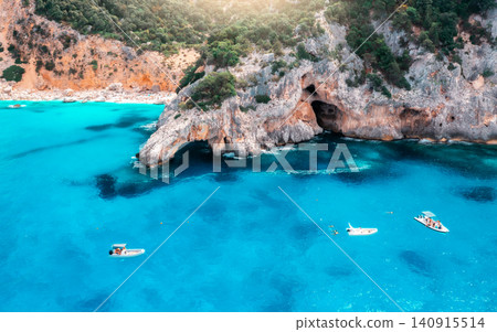 Aerial view of rocks and mountains, blue bay, beach, boats Aerial view of rocks and mountains, blue bay, beach, boats 140915514