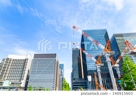 Large cranes and skyscrapers at a construction site Large cranes and skyscrapers at a construction site 140915603